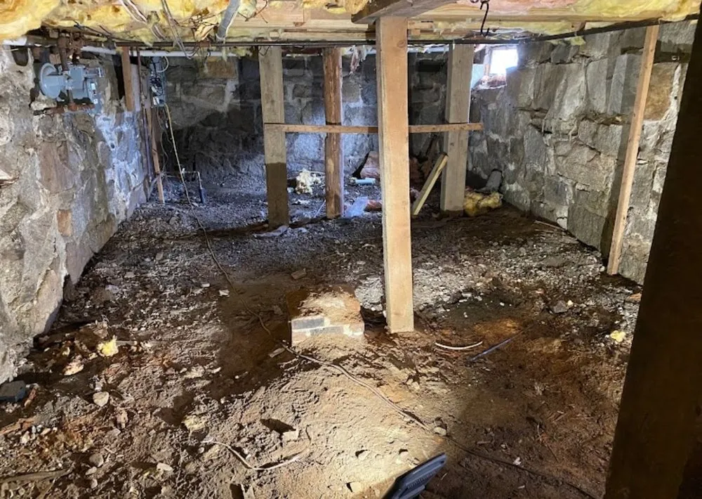 Basement stripped back to the stone foundation before waterproofing