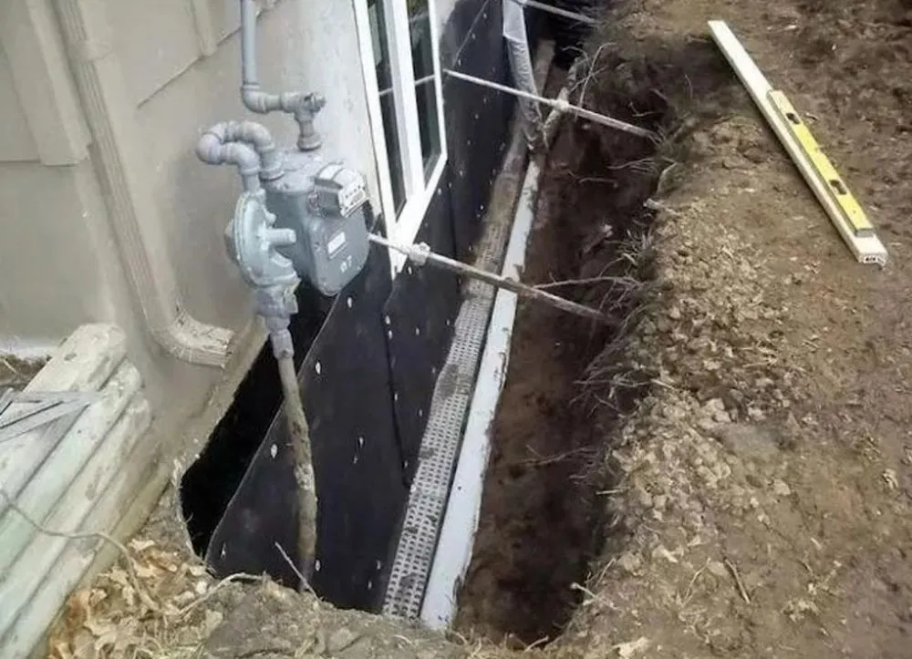 Waterproofing membrane applied to an excavated foundation wall