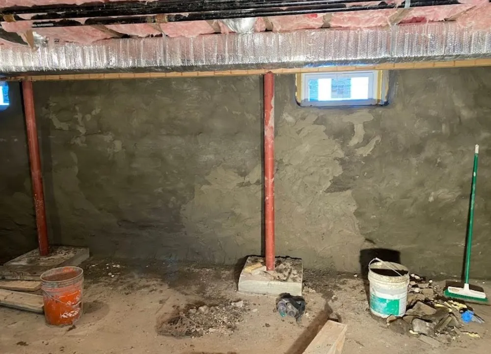 Interior foundation wall parged and sealed during basement waterproofing