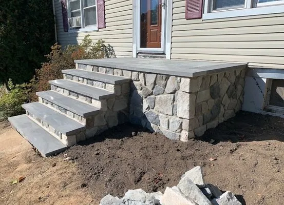 Fieldstone-faced front stoop with granite steps